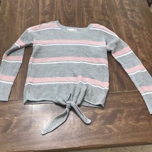Gray and pink and white striped sweater.